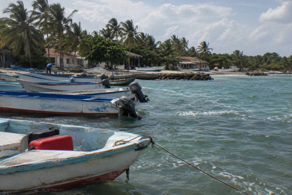 Fishing boats moored in a small caribbean harbor at morning