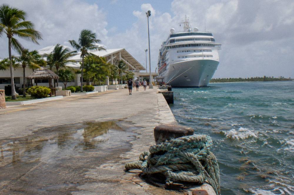Cruise ship at berth beside a newly expanded terminal building