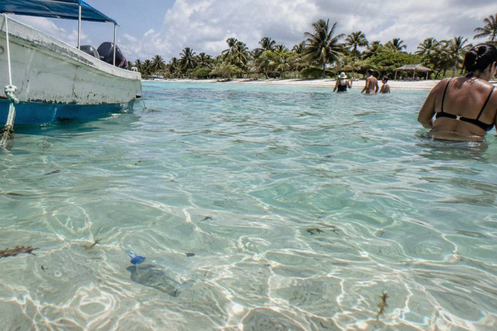 Standing depth of clear water over pale sand with gentle ripples on the surface