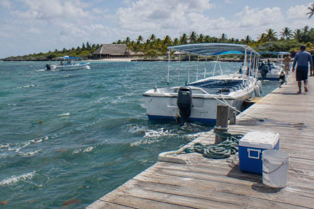 Tour boats moored at a pier along the Bayahibe waterfront