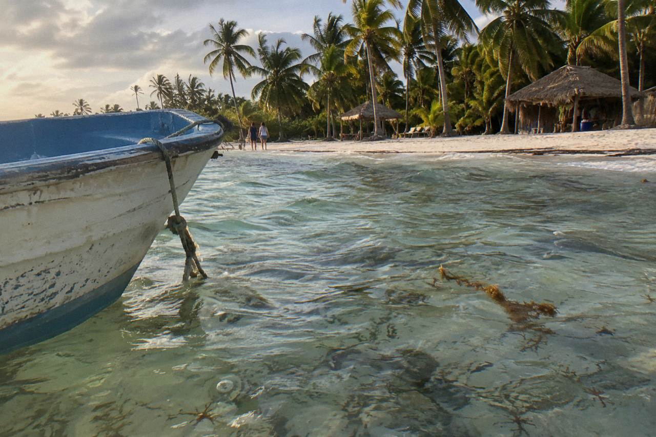 Clear shallow Caribbean water over a sandy seabed with patches of seagrass near Saona Island