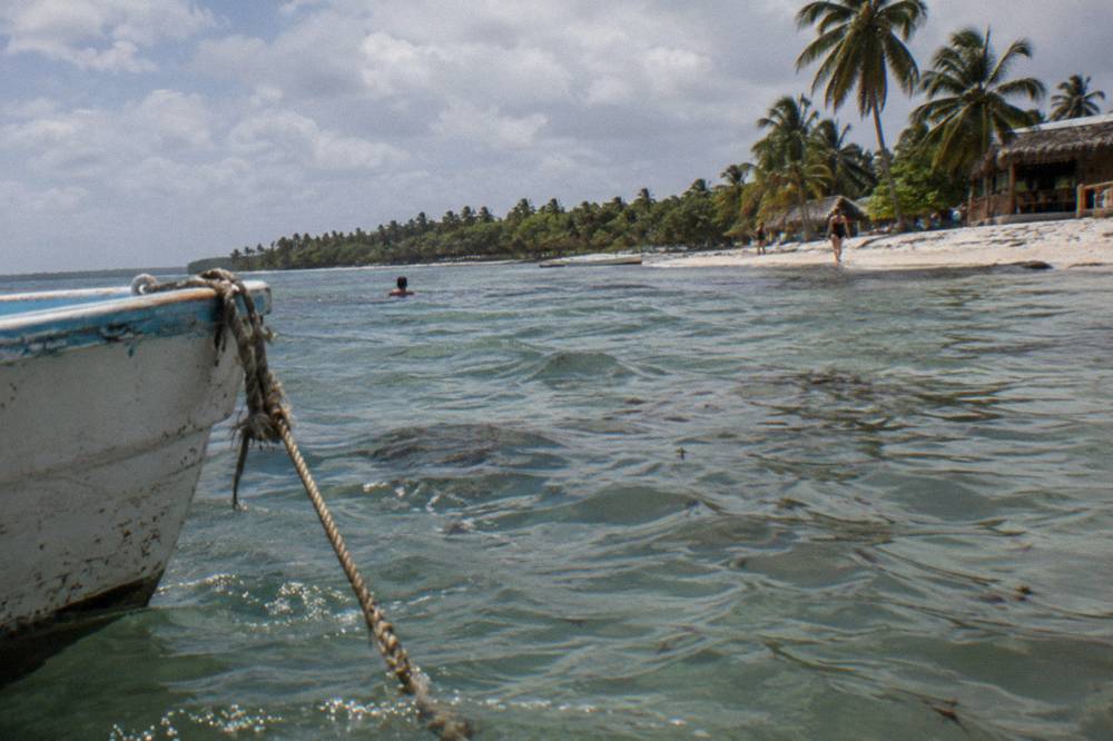 A calm shallow lagoon with gentle ripples and distant green shoreline
